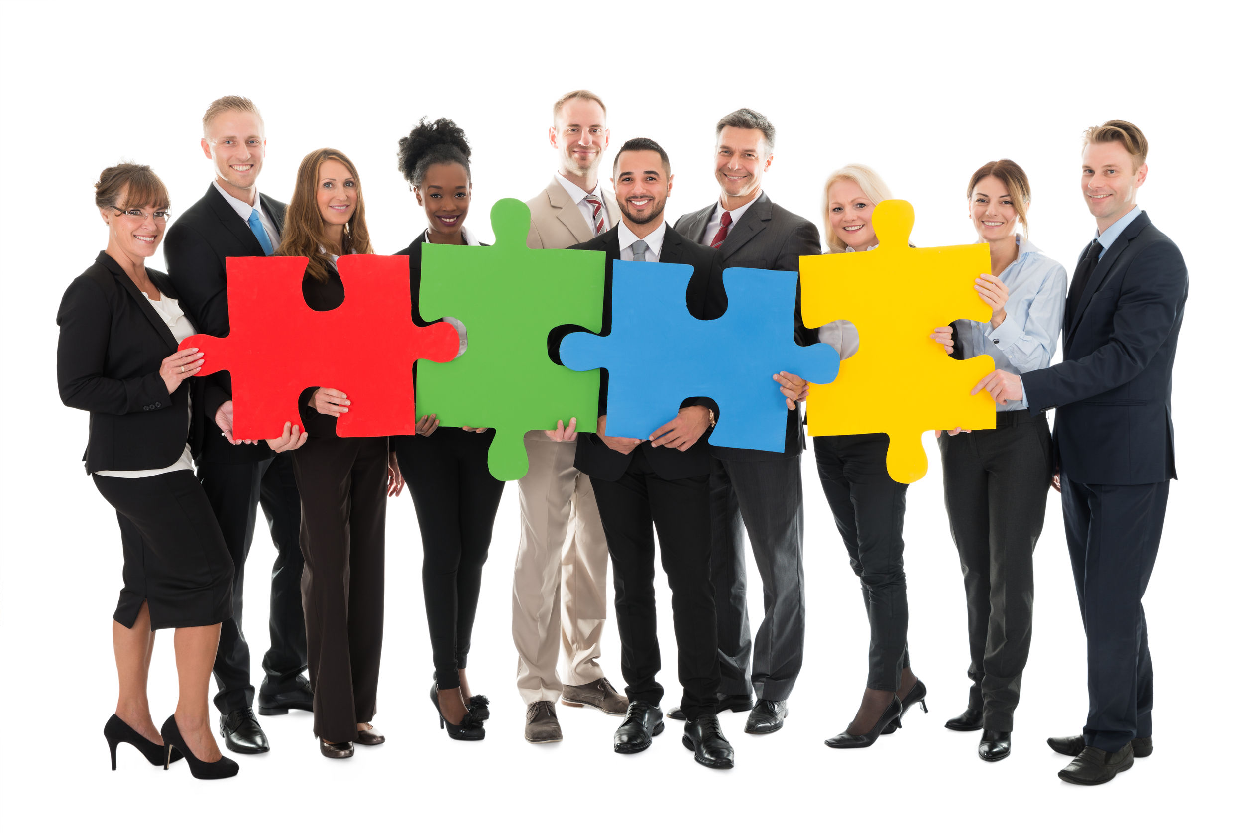 50244323 - full length portrait of happy business team holding jigsaw pieces against white background